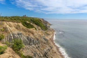 Mohegan Bluffs soar up from the Atlantic Ocean near the Southeast Lighthouse in New Shoreham.