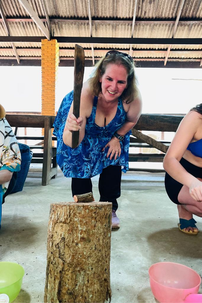 Trying to crush the tree chunk that became our soapy scrubber at Smile Elephant Sanctuary in Chiang Mai