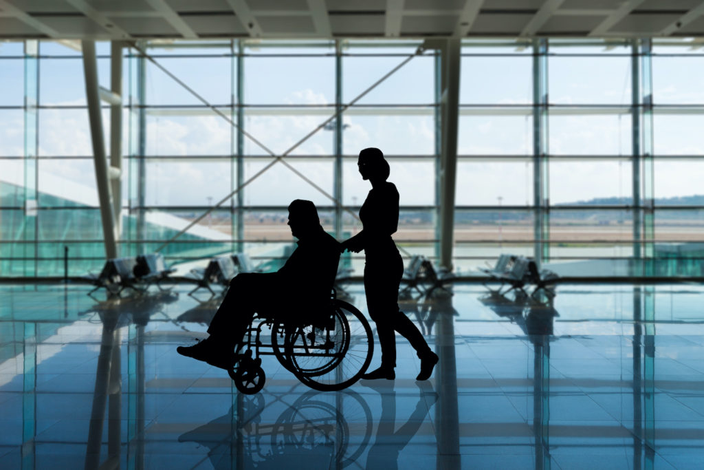 Person being pushed in a wheelchair at the airport