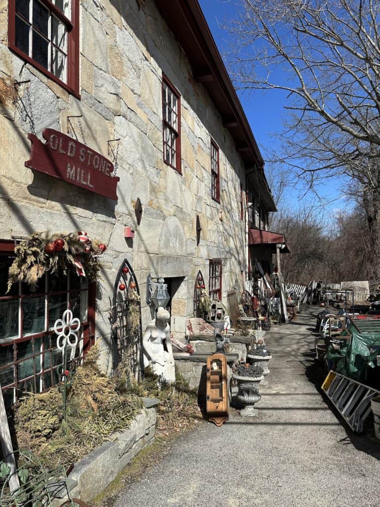 Old Stone Mill Antiques and antiques outside the building in Chepachet.