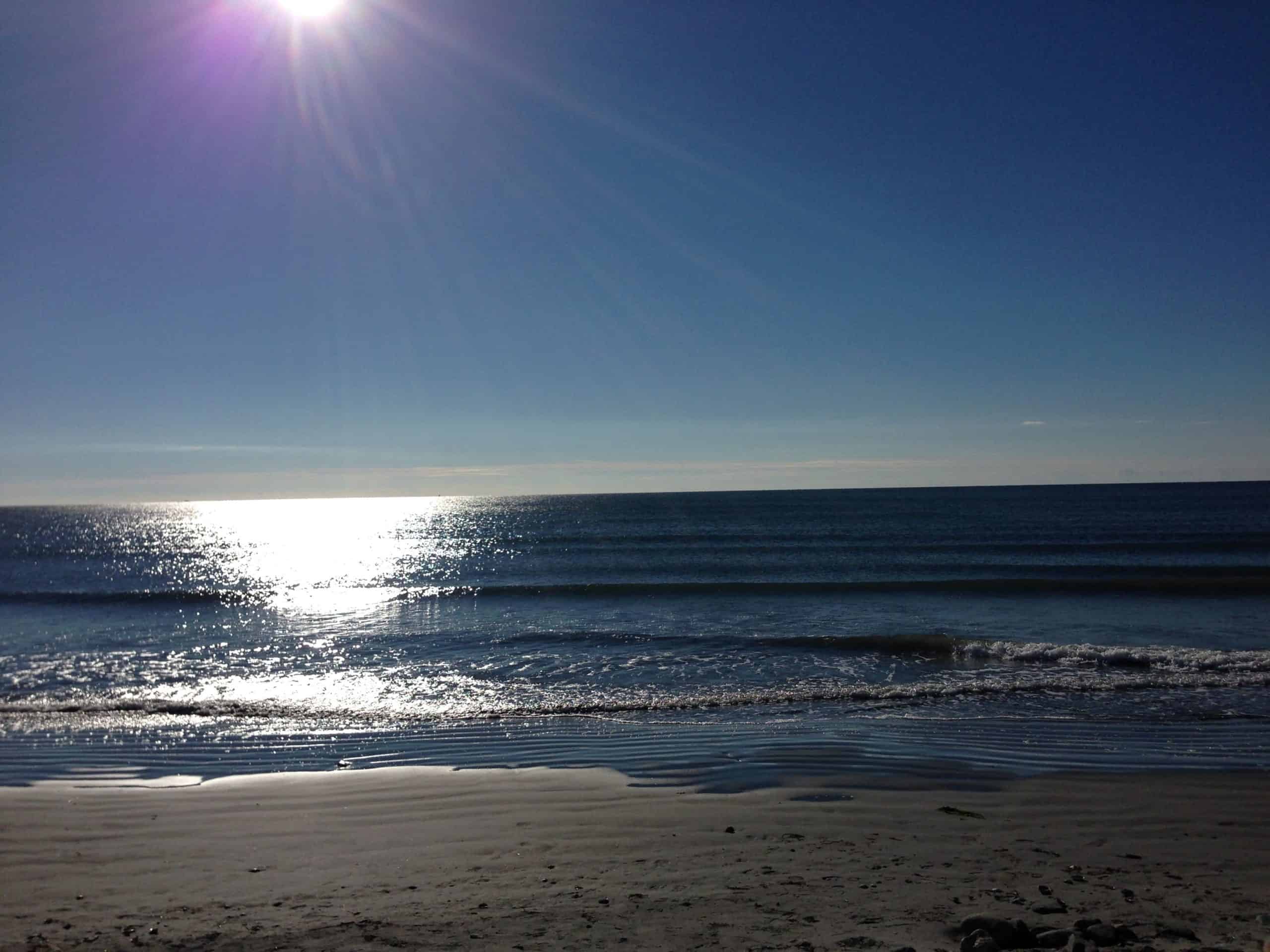 The sun shining on the Newport Rhode Island Beaches of First Beach along the Cliff Walk.
