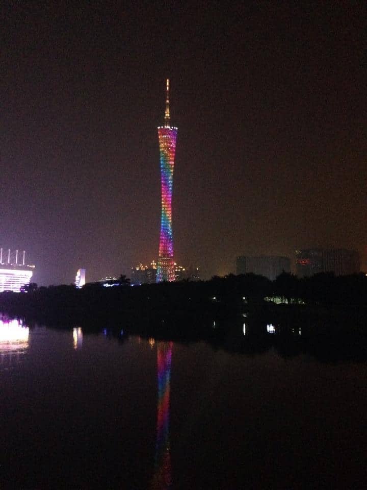 The Canton Tower lit up brilliantly at night.