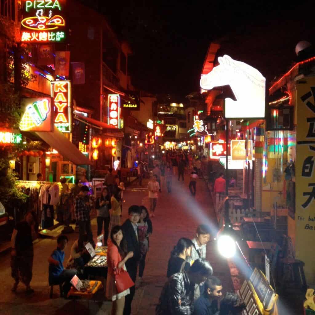 A bright and busy night scene on the shopping and restaurant filled West Street in Yangshuo.