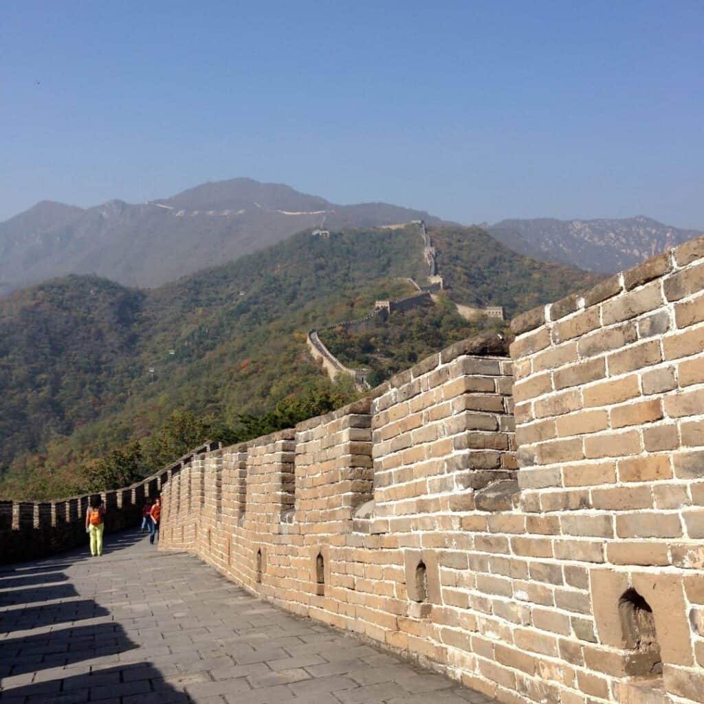 The Great Wall of China stretching across the mountains in the distance.