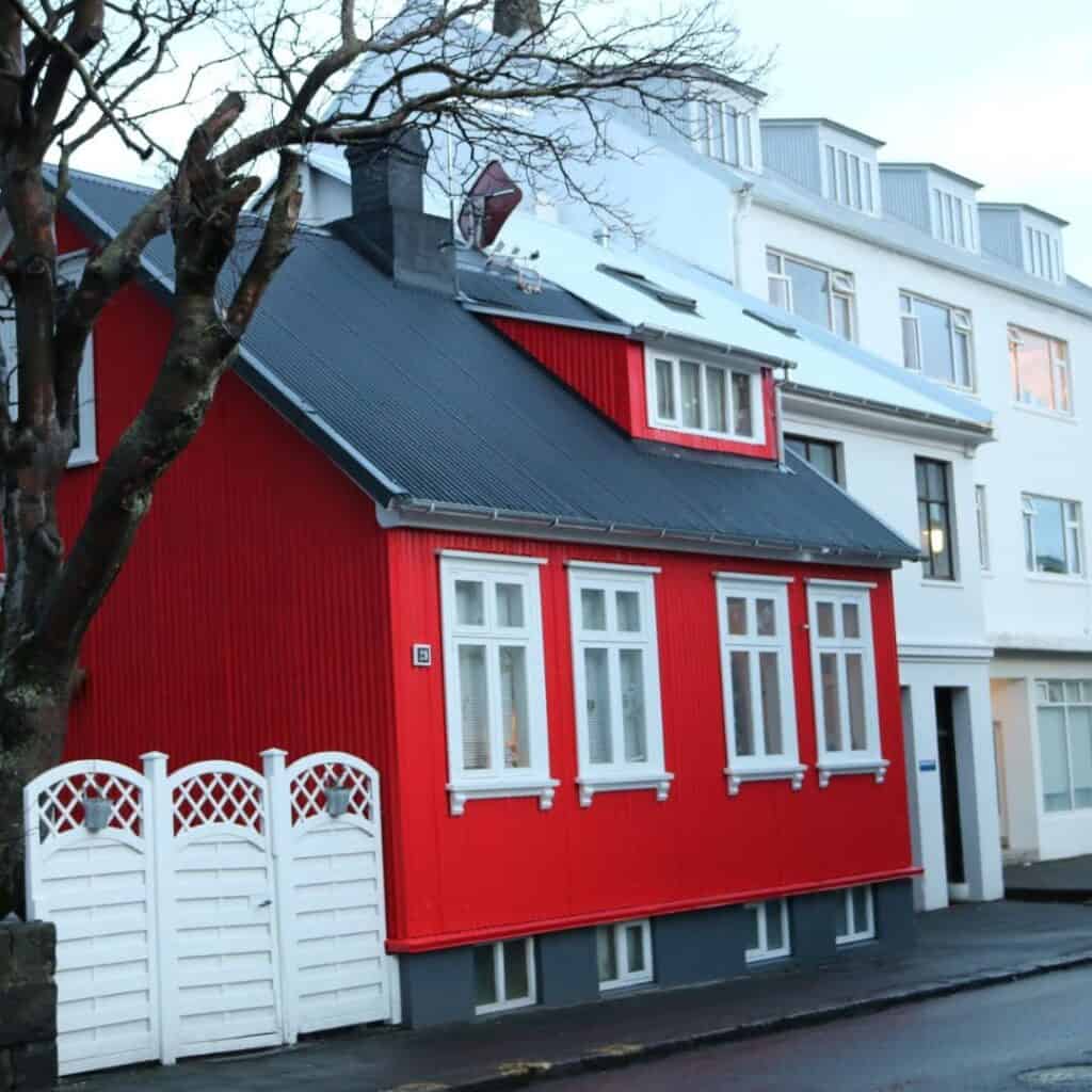 Small bright red house on a street in Reykjavik.