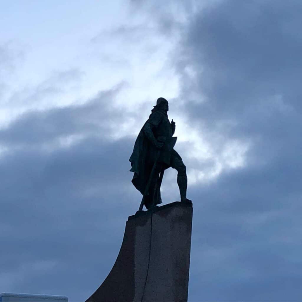 A statue of Leif Erickson in front of the cloudy sky in Iceland.