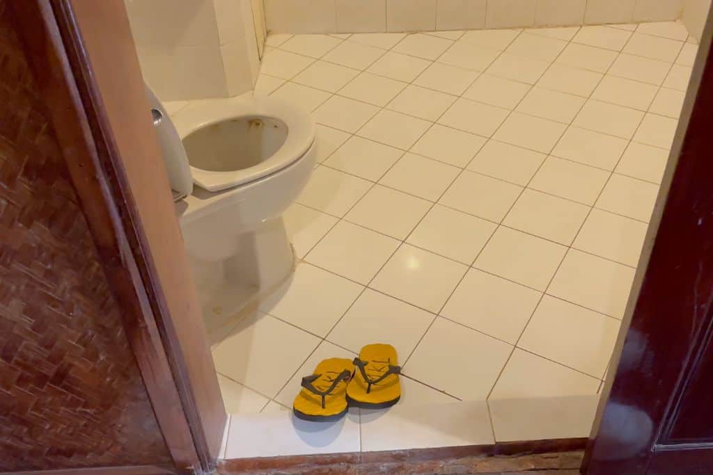 Slippers at the entrance to the wet room style bathroom at the Mekong Riverside Lodge