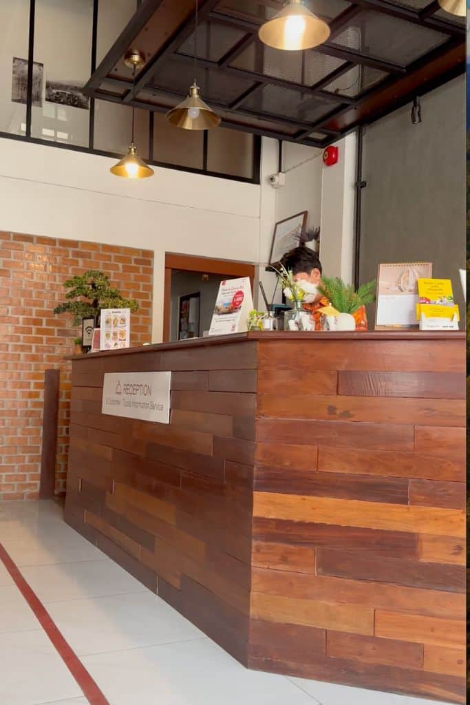 The lobby of the Old City Wall Inn with the receptionist behind the desk.