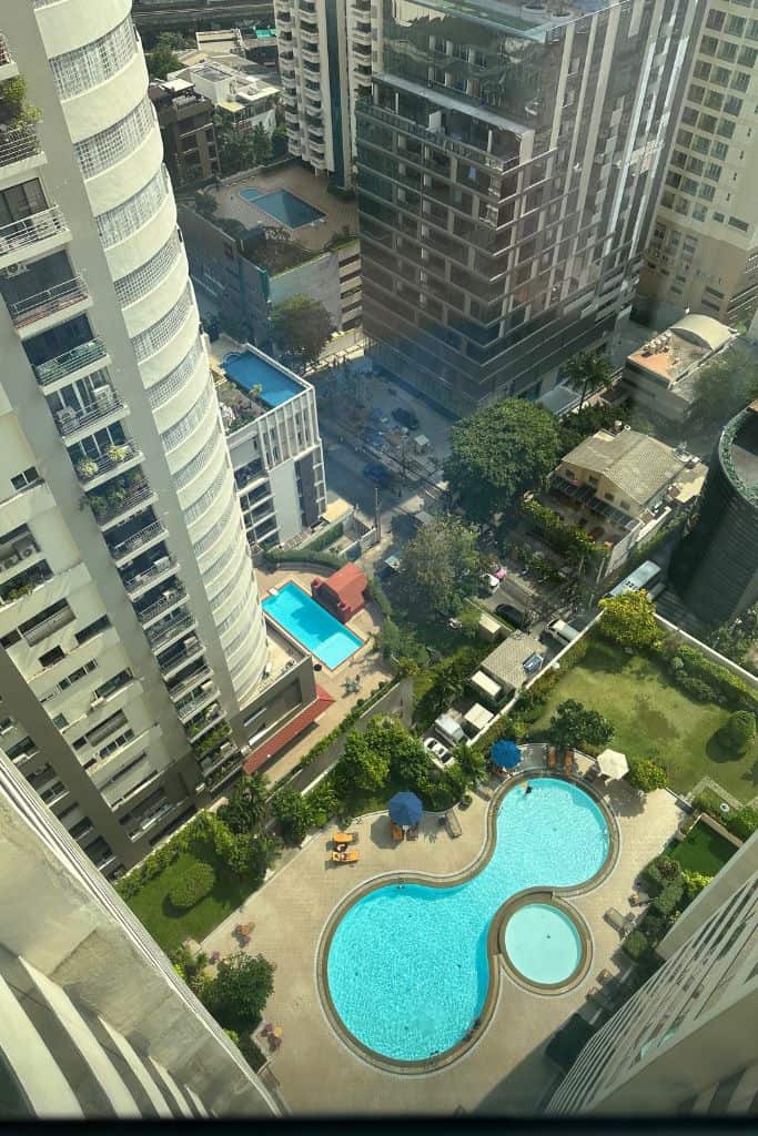 The view from the 29th floor of the hotel looking down on the city of Bangkok and swimming pools below.