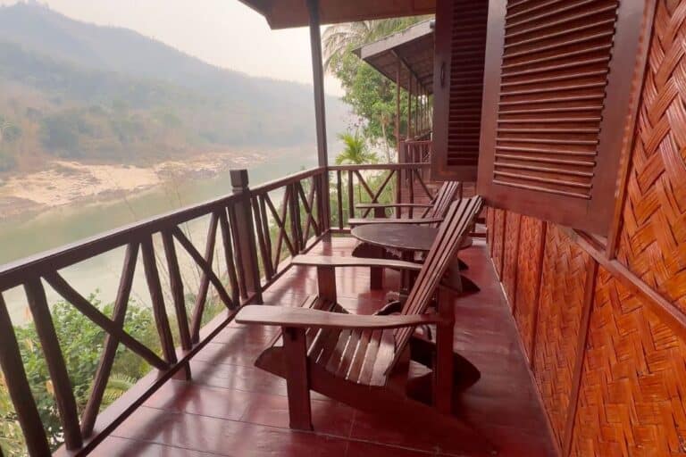 The redwood deck and adirondack chairs on the deck overlooking the Mekong River.