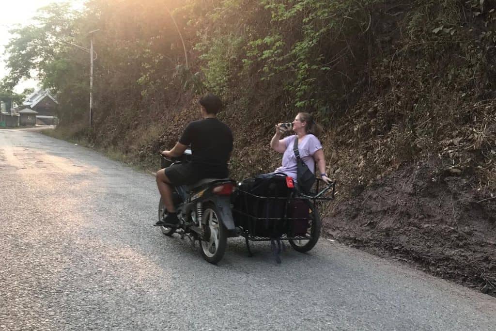 Me riding on a sidecar in a cart going up the hill toward the lodge.