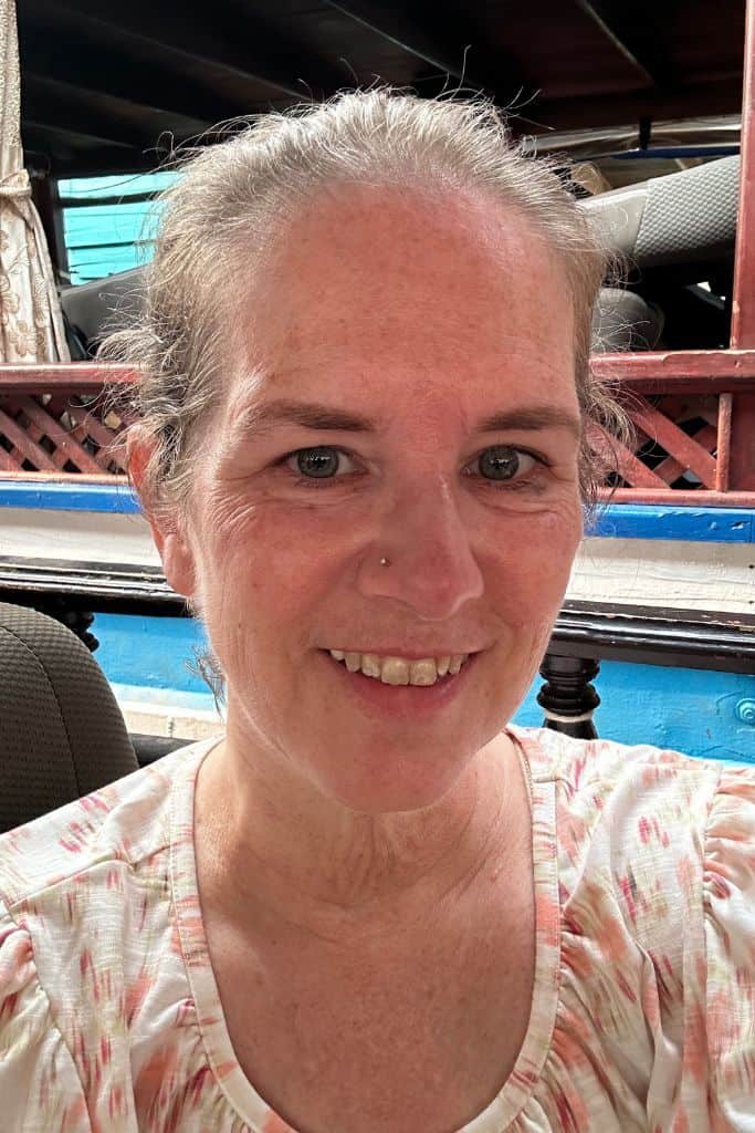 a selfie of me smiling while sitting on the Mekong River slowboat