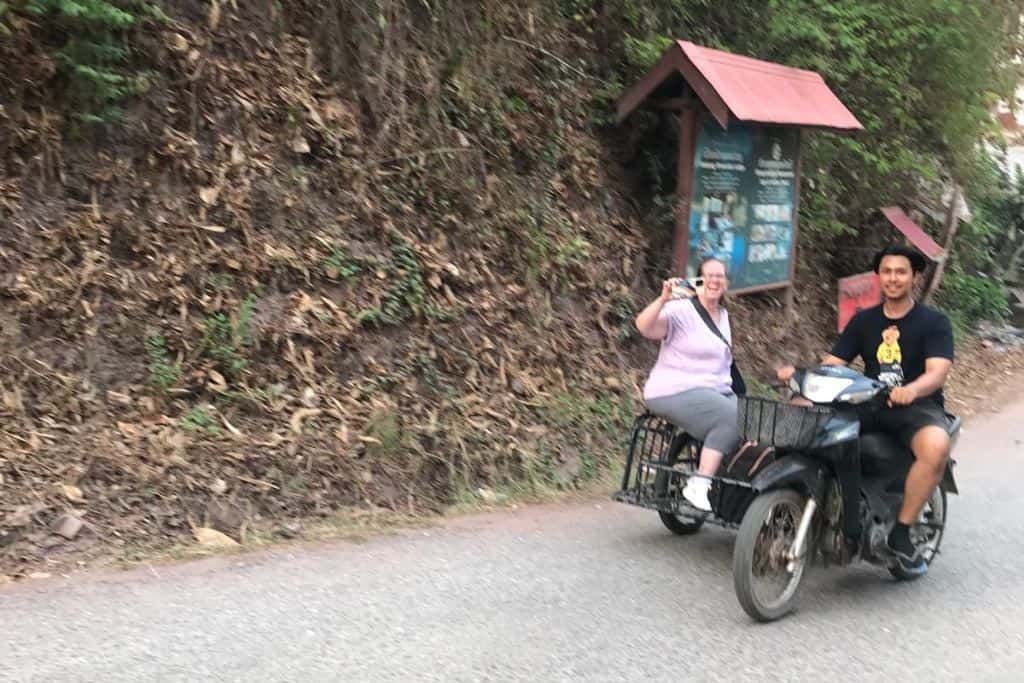 Me riding in a motorcycle in a sidecar on the steep road up to the Lodge.