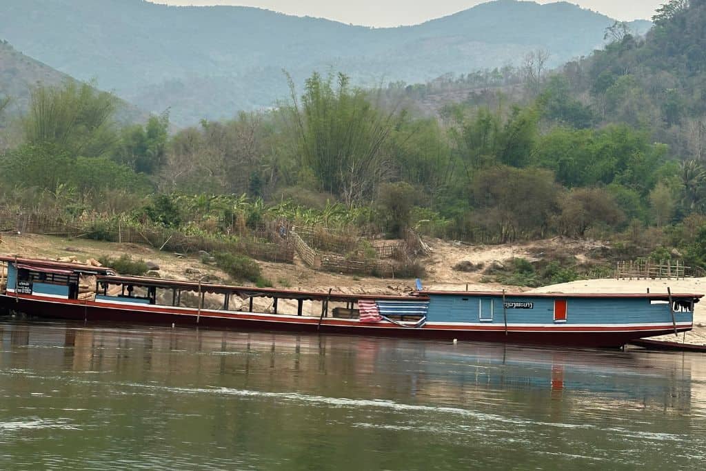 a slowboat sitting empty in the Mekong River