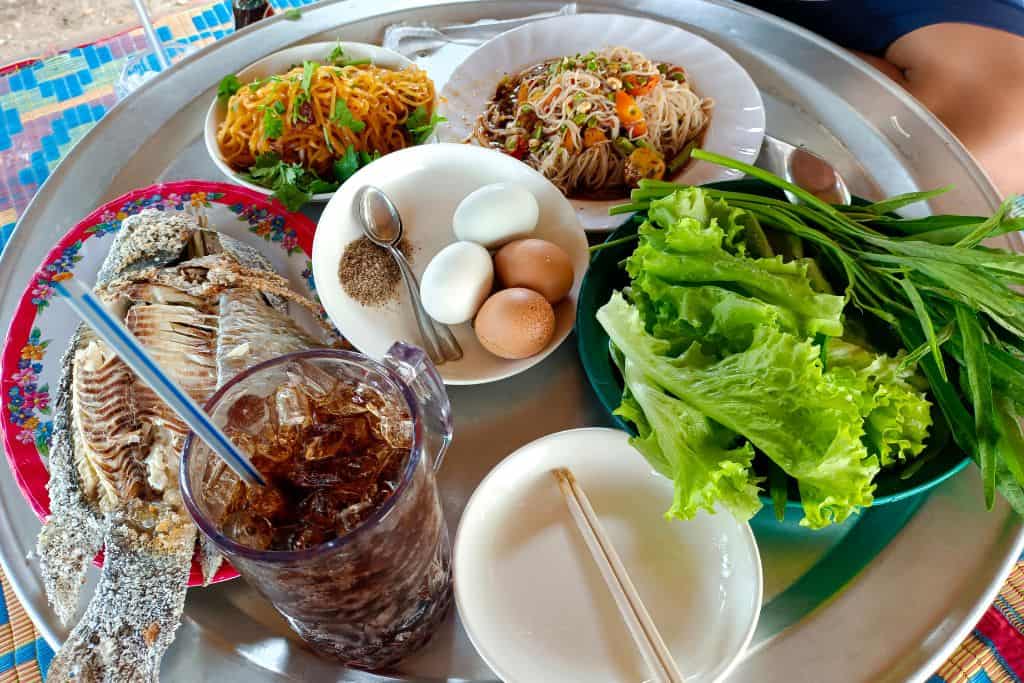 A picture of a Laotian meal with several different dishes.