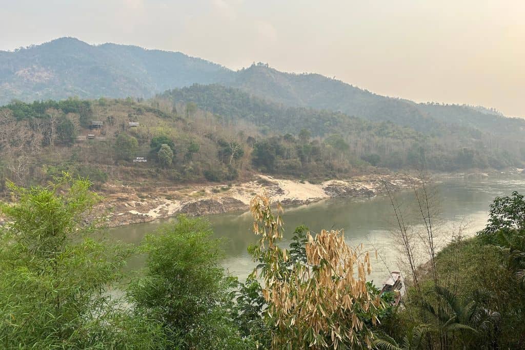 The Mekong River below with the karst mountains rising up from the far bank.