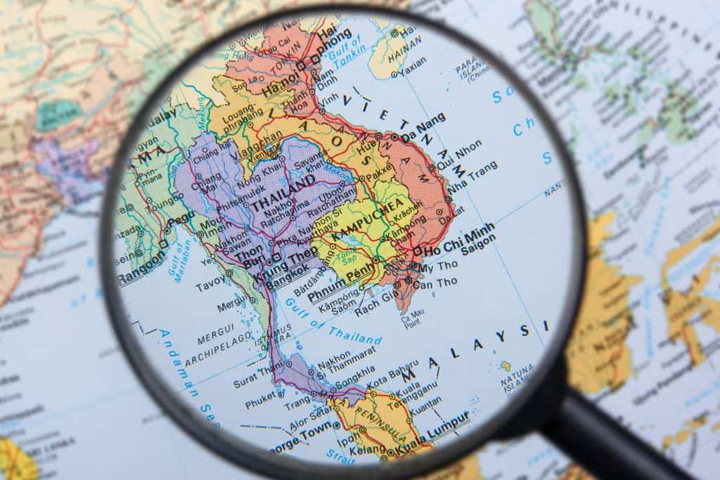 A map of Laos highlighted my a magnifying glass.