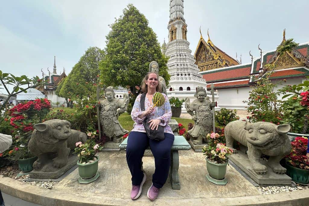 A photo of me sitting at a temple wearing my crossbody purse that stays close to my body.