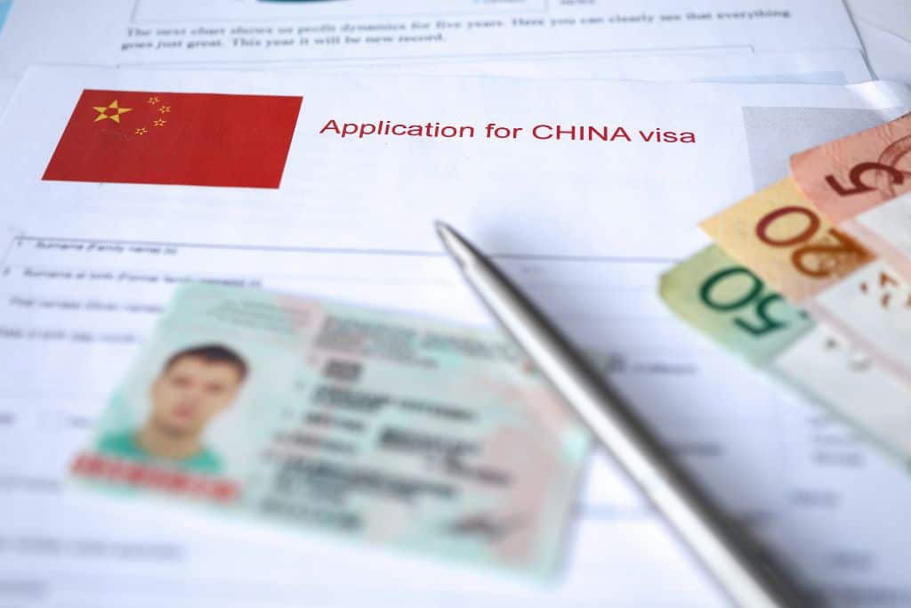 A license sitting on top an application for a Chinese visa.