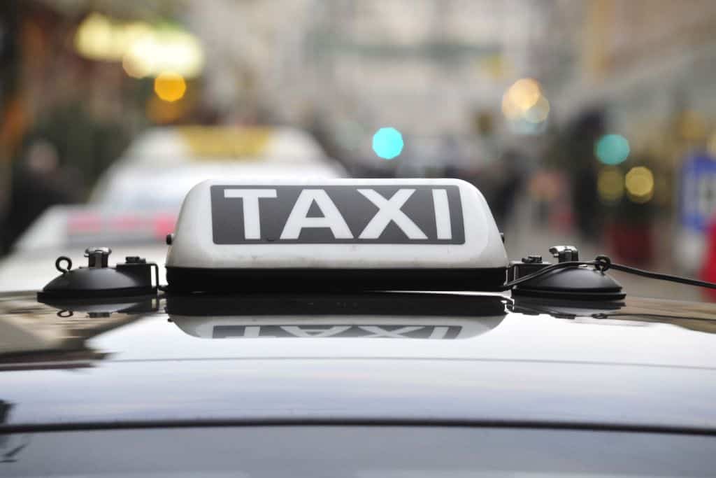 A taxi with a white taxi sign.