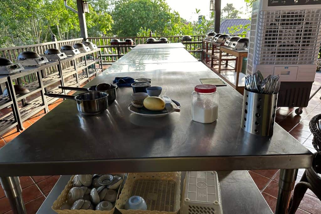 The open air kitchen with gleaming stainless steel work counters to prepare the food.