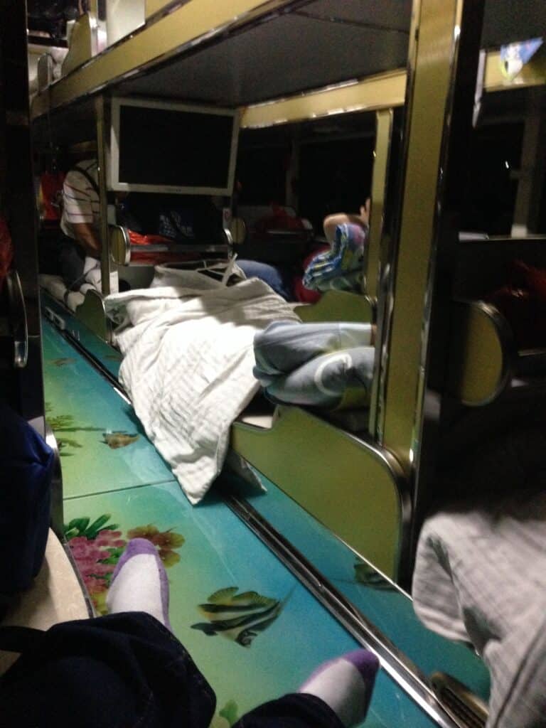 A sleeper bus with bunks to lay down and sleep during an evening ride to your destination.