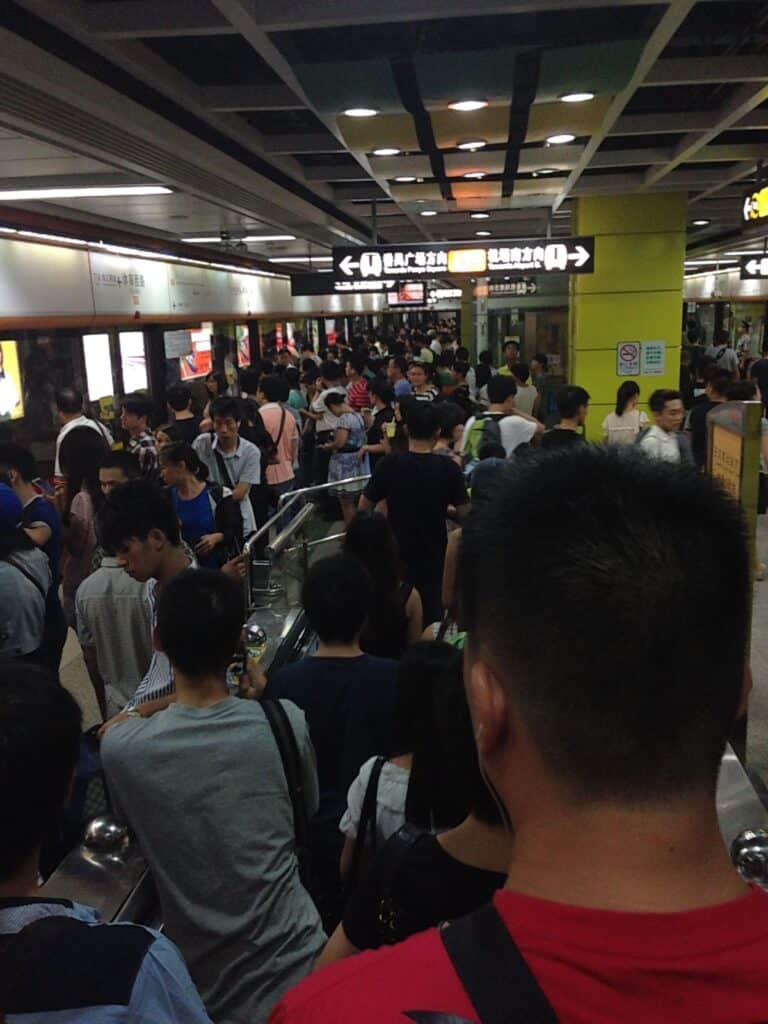 A very crowded subway station during rush hour.