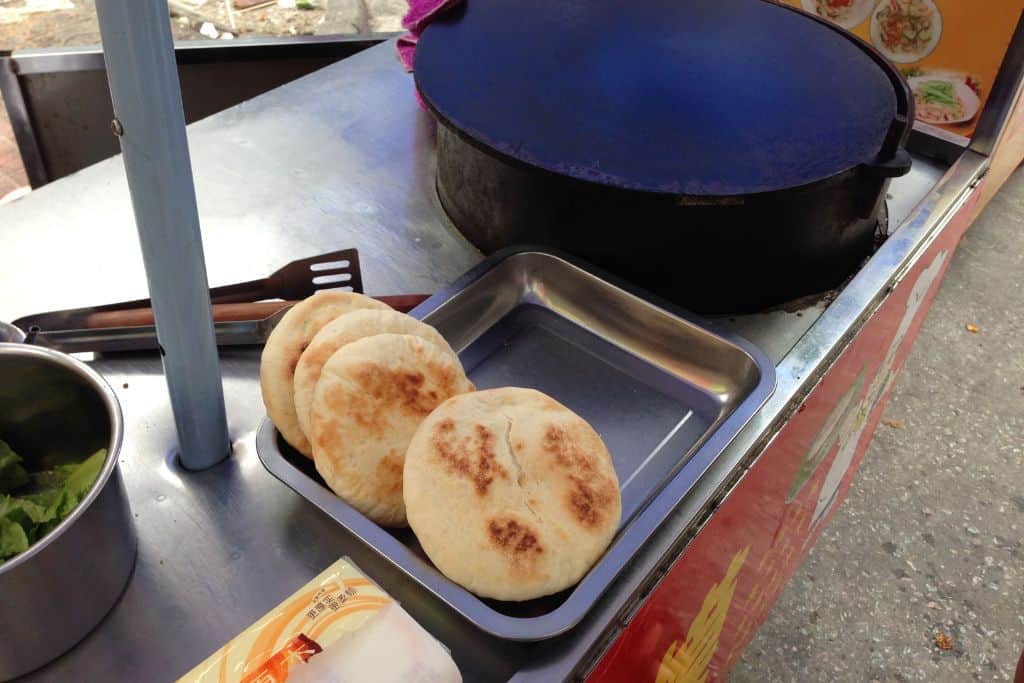 Homemade pita pocket breads stuffed with a simmered beef stew served at a stall on the street.